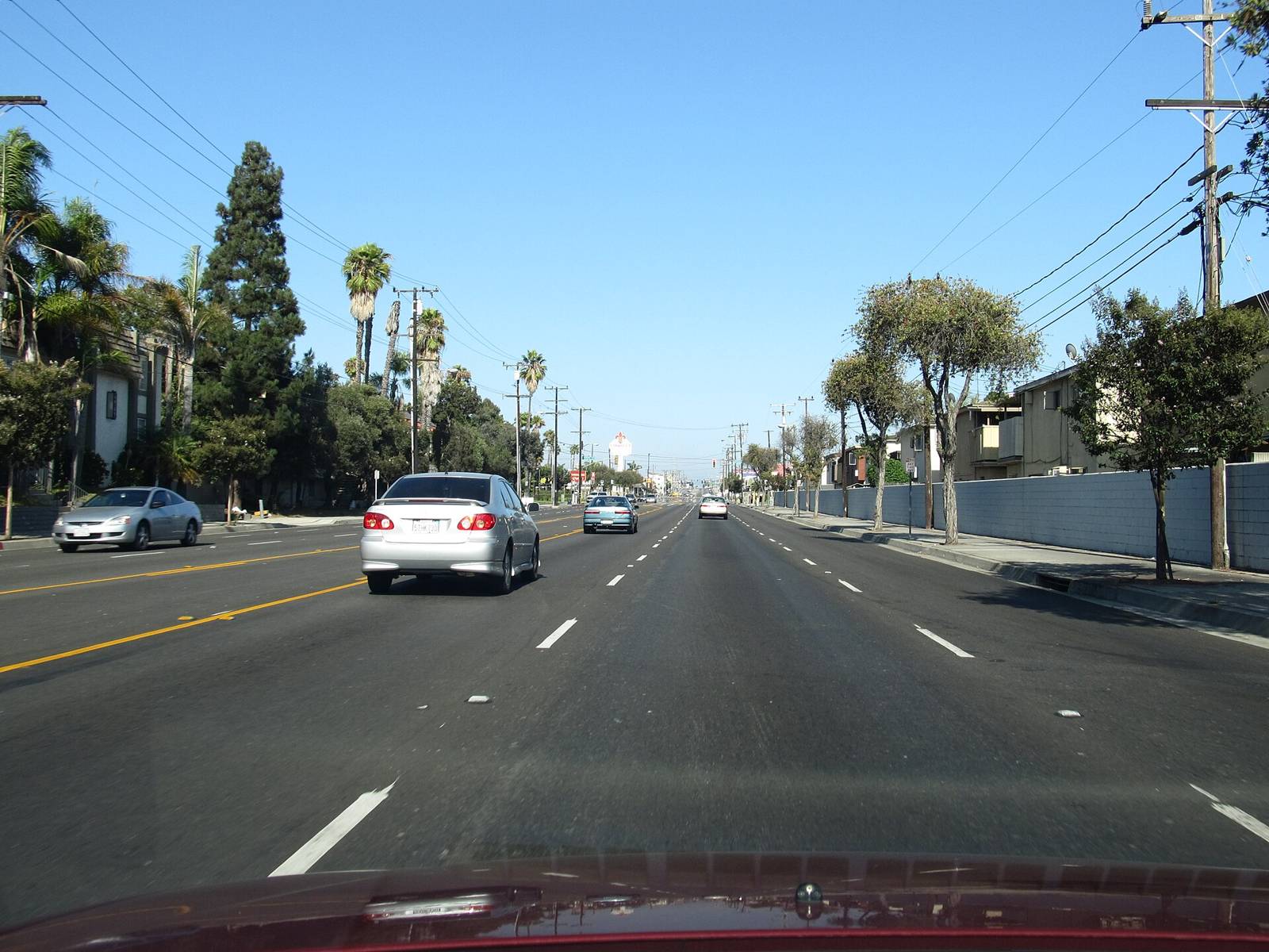 Palm-lined Rosecrans Avenue in Gardena, CA 90247 on a sunny day